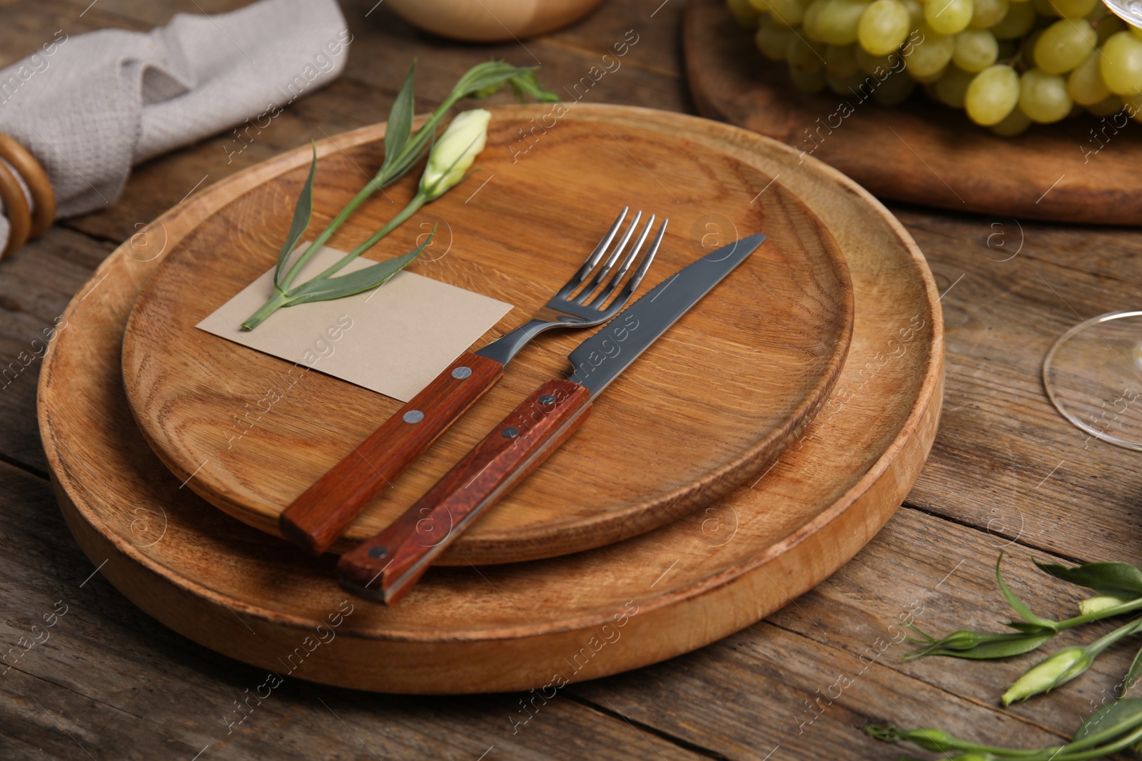 Photo of Elegant festive table setting with blank card on wooden background