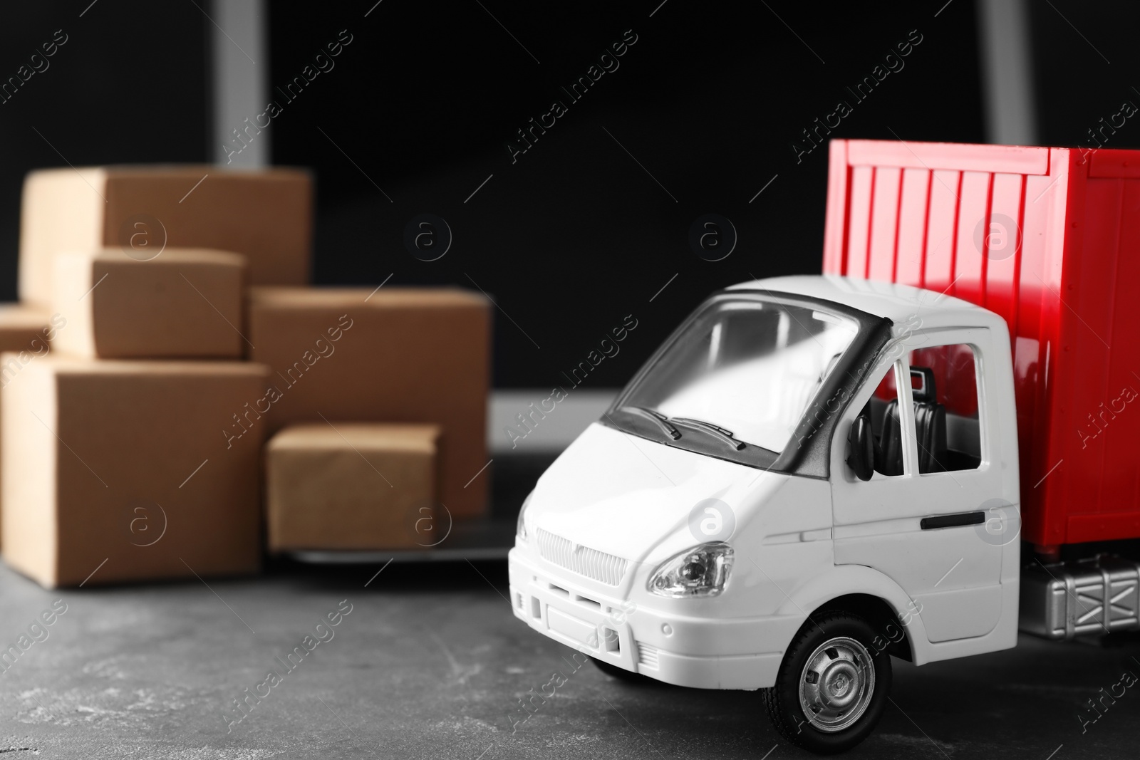 Photo of Toy truck on table. Logistics and wholesale concept