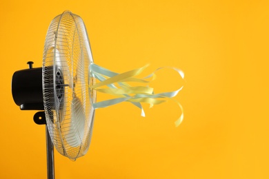 Photo of Electric fan on yellow background. Summer heat