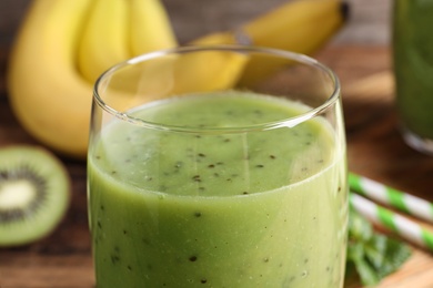 Photo of Delicious kiwi smoothie in glass, closeup view