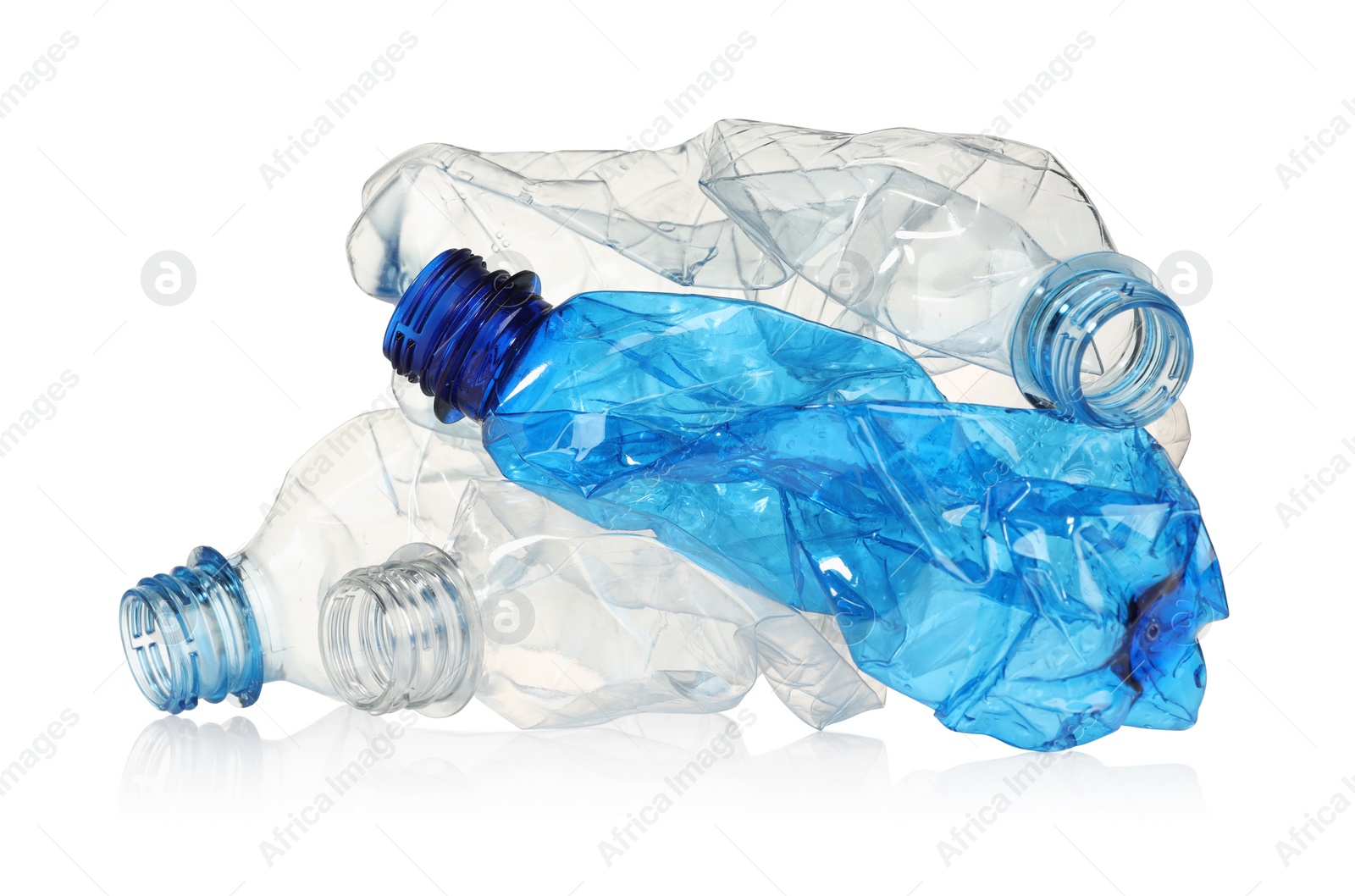 Photo of Crumpled disposable plastic bottles isolated on white