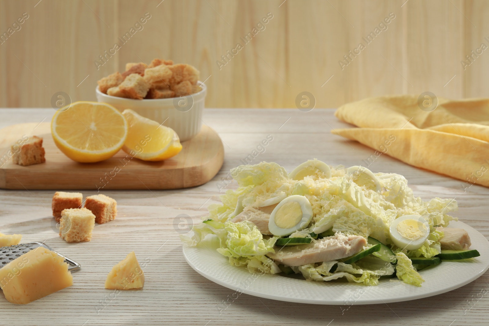 Photo of Delicious salad with Chinese cabbage, eggs and meat served on wooden table, space for text