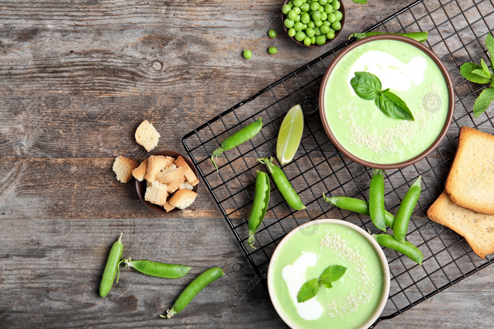 Photo of Flat lay composition with green pea soup on wooden background