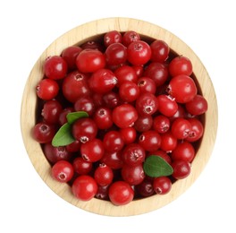 Photo of Wooden bowl of fresh ripe cranberries with leaves isolated on white, top view