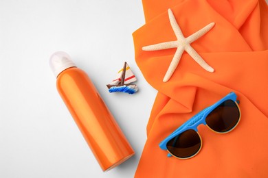 Flat lay composition with bottle of sunscreen on white background