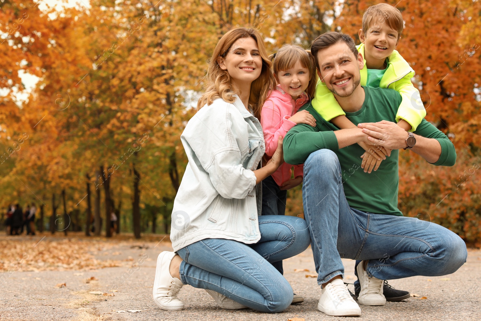 Photo of Happy family with children together in park. Autumn walk