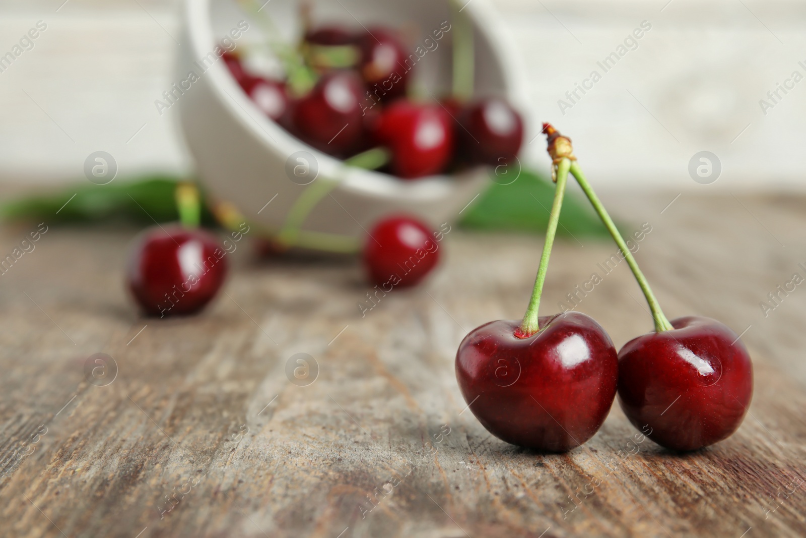 Photo of Sweet red cherries on wooden table