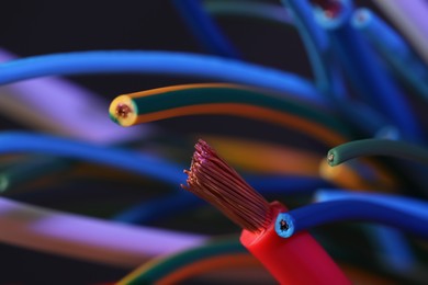 Photo of Colorful cables on blurred background, closeup. Electrician's supply