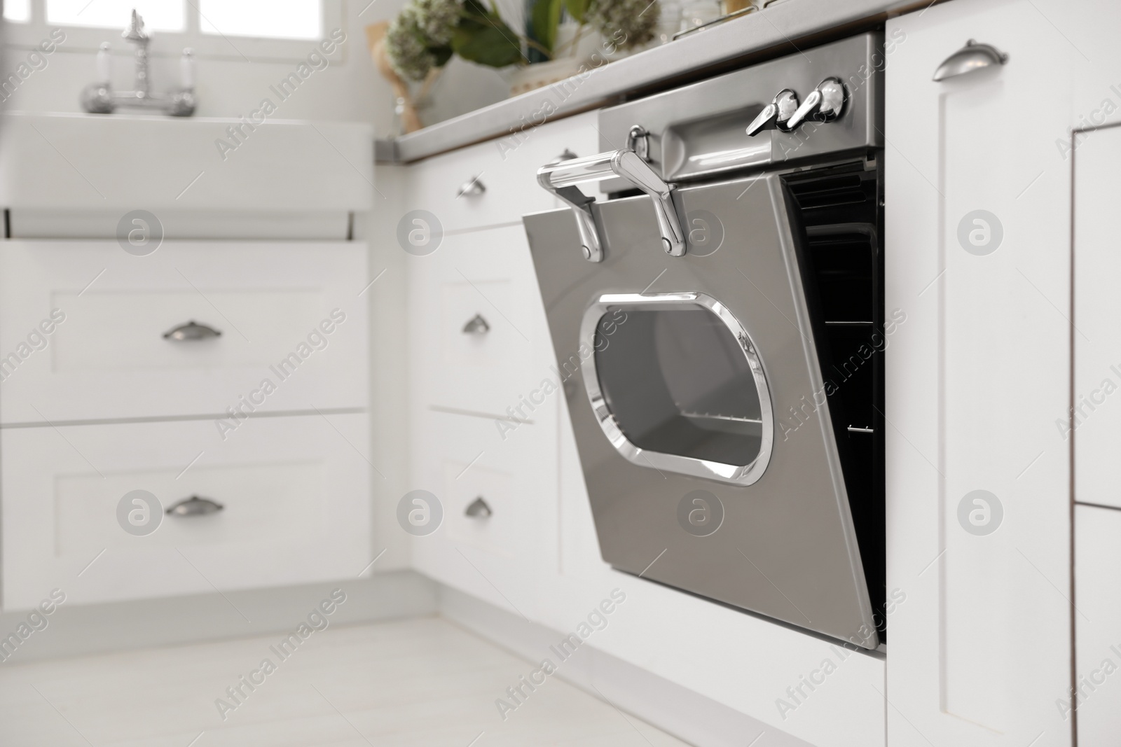 Photo of New modern oven in stylish kitchen. Cooking appliance