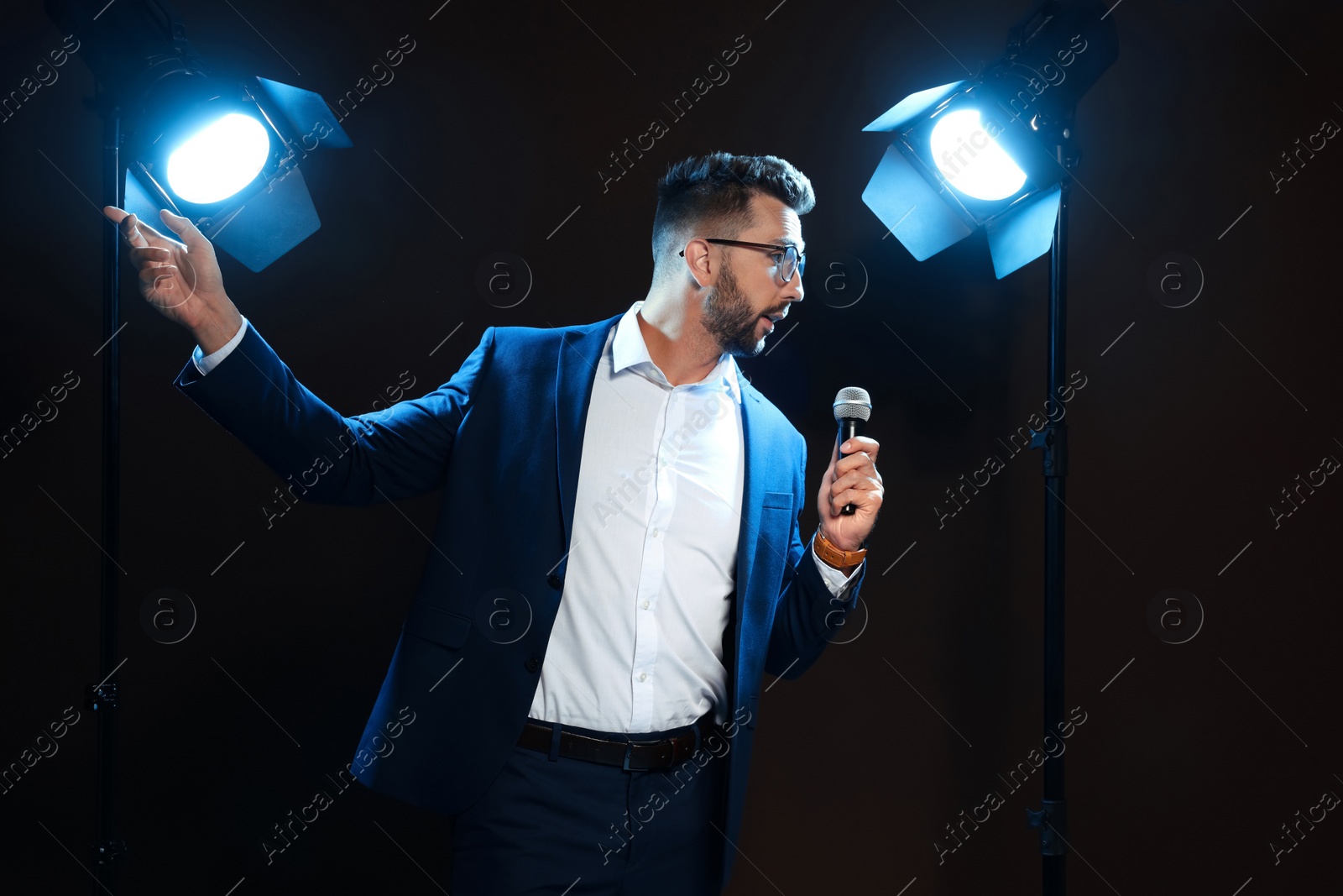 Photo of Motivational speaker with microphone performing on stage