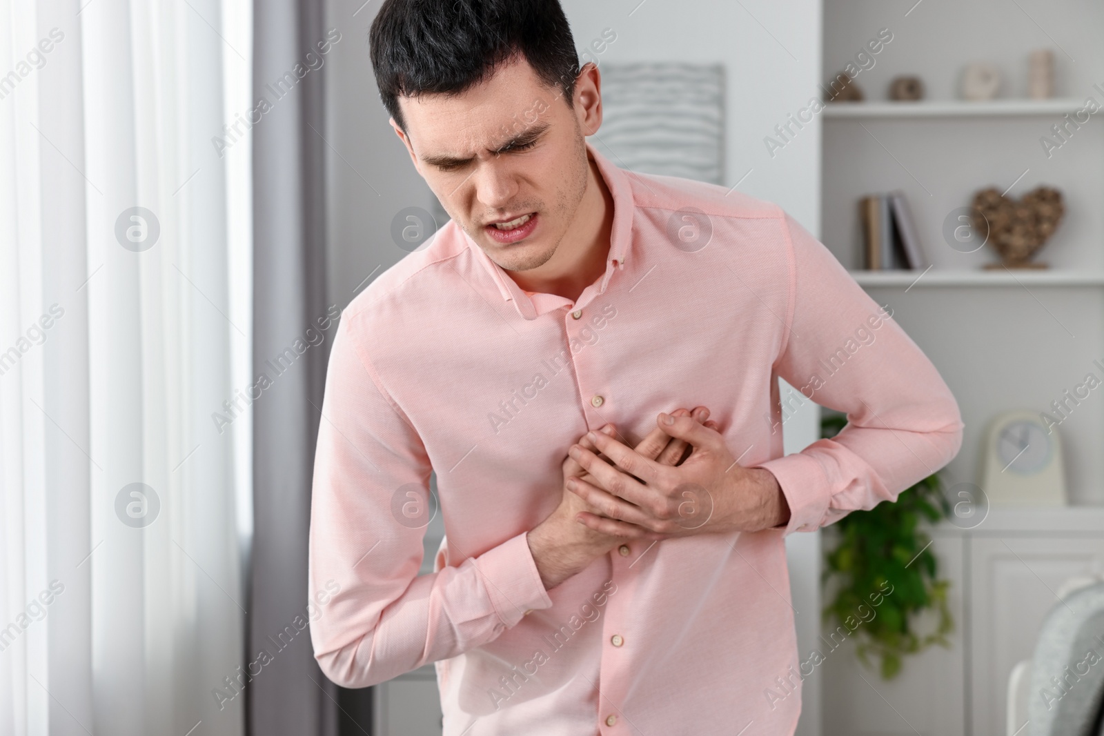 Photo of Young man suffering from heart hurt at home