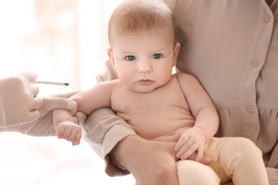 Doctor vaccinating baby in clinic