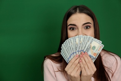 Photo of Young woman with money on color background