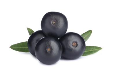 Photo of Pile of fresh ripe acai berries and green leaves on white background