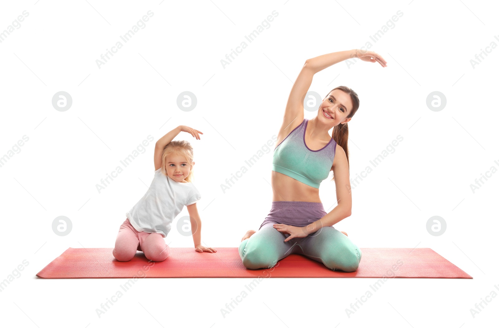 Photo of Young woman and her daughter doing exercise isolated on white. Home fitness