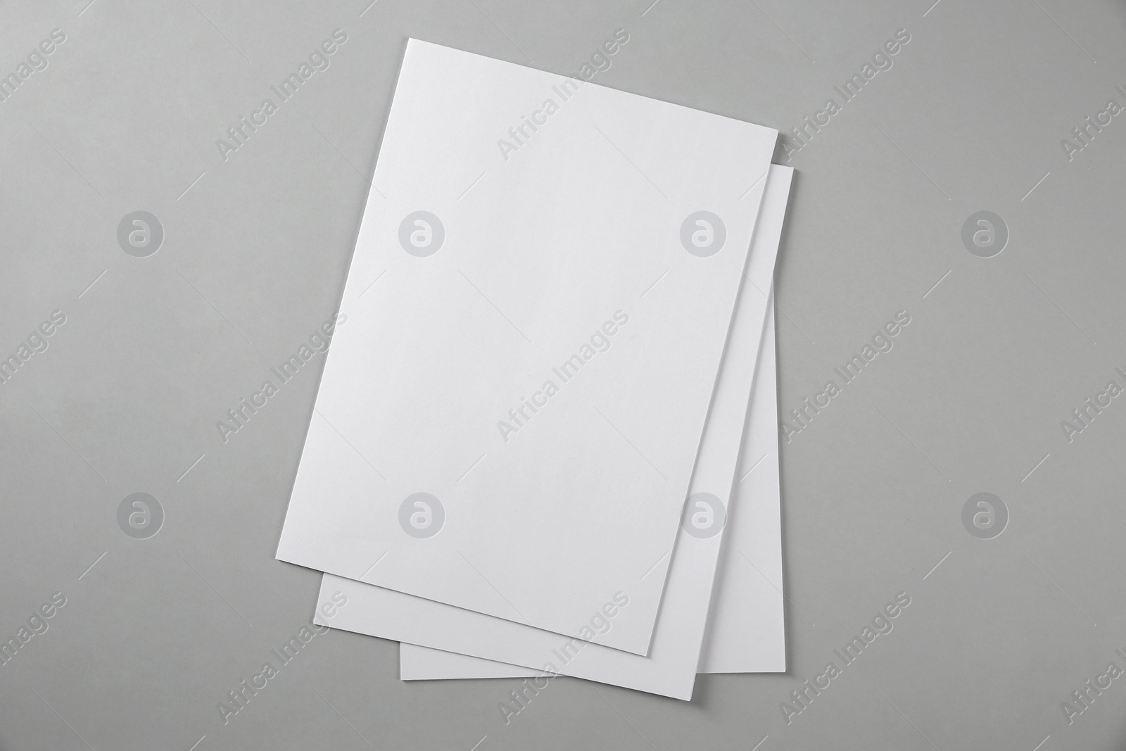 Photo of Blank brochures on grey background, top view. Mockup for design