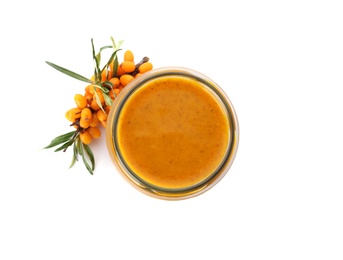 Delicious sea buckthorn jam in jar and fresh berries on white background, top view