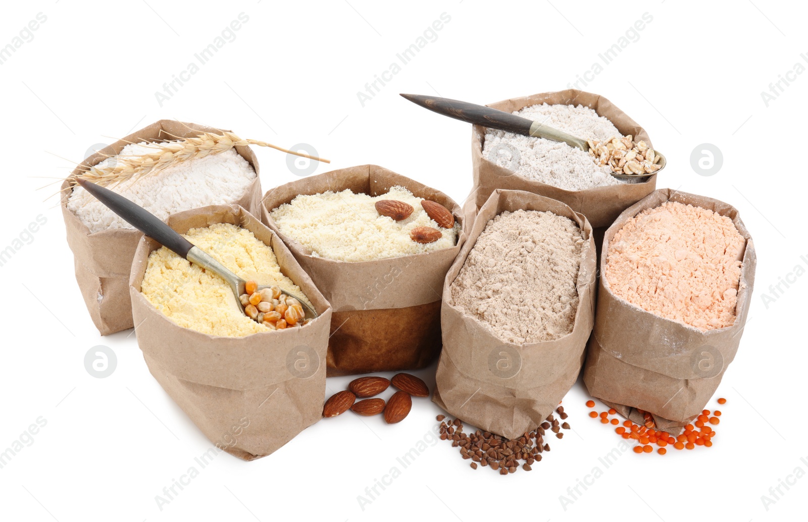 Photo of Paper bags with different types of flour on white background