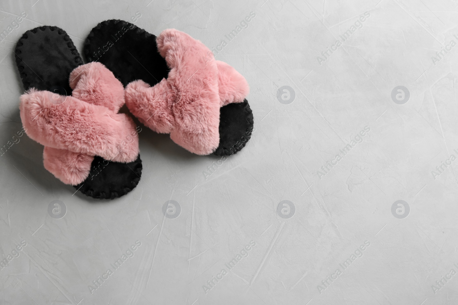 Photo of Pair of soft slippers on light grey background, flat lay. Space for text