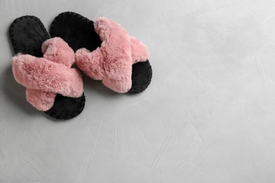 Photo of Pair of soft slippers on light grey background, flat lay. Space for text