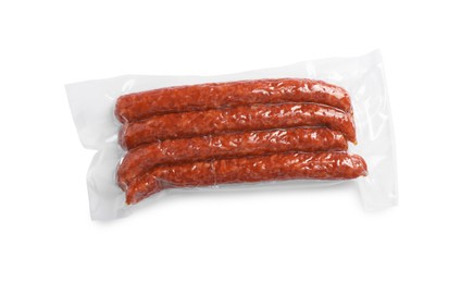 Photo of Pack of thin dry smoked sausages isolated on white, top view