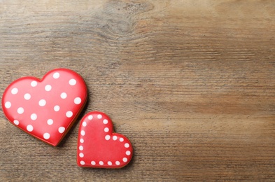 Heart shaped cookies on wooden table, flat lay with space for text. Valentine's day treat