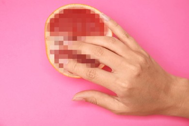Image of Young woman touching half of grapefruit on pink background, top view. Sex concept
