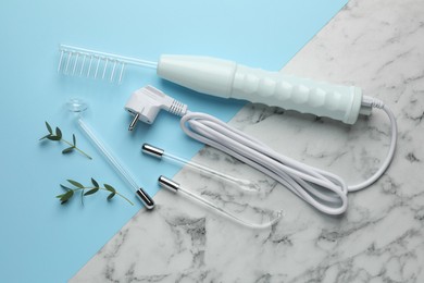 Photo of Flat lay composition with darsonval and different nozzles on color background