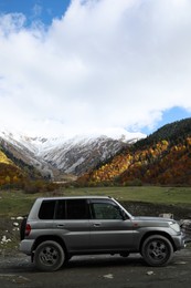 Photo of Picturesque view of modern car in beautiful mountains on autumn day