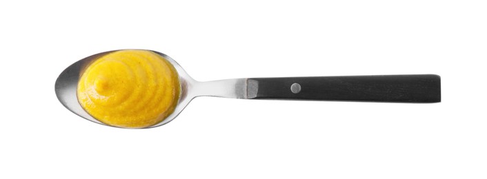 Photo of Fresh tasty mustard sauce in spoon isolated on white, top view