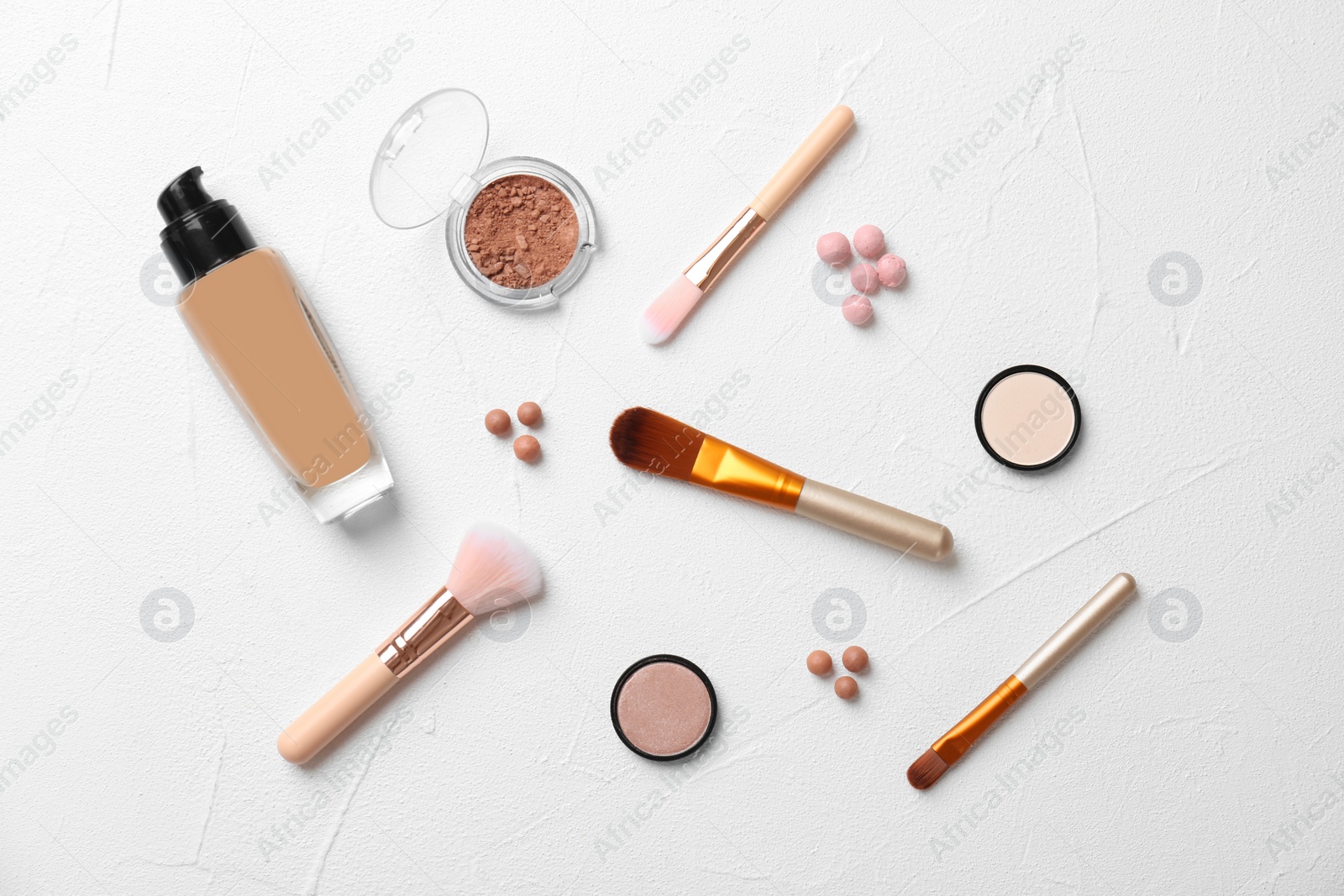 Photo of Flat lay composition with cosmetic products and makeup brushes on light background