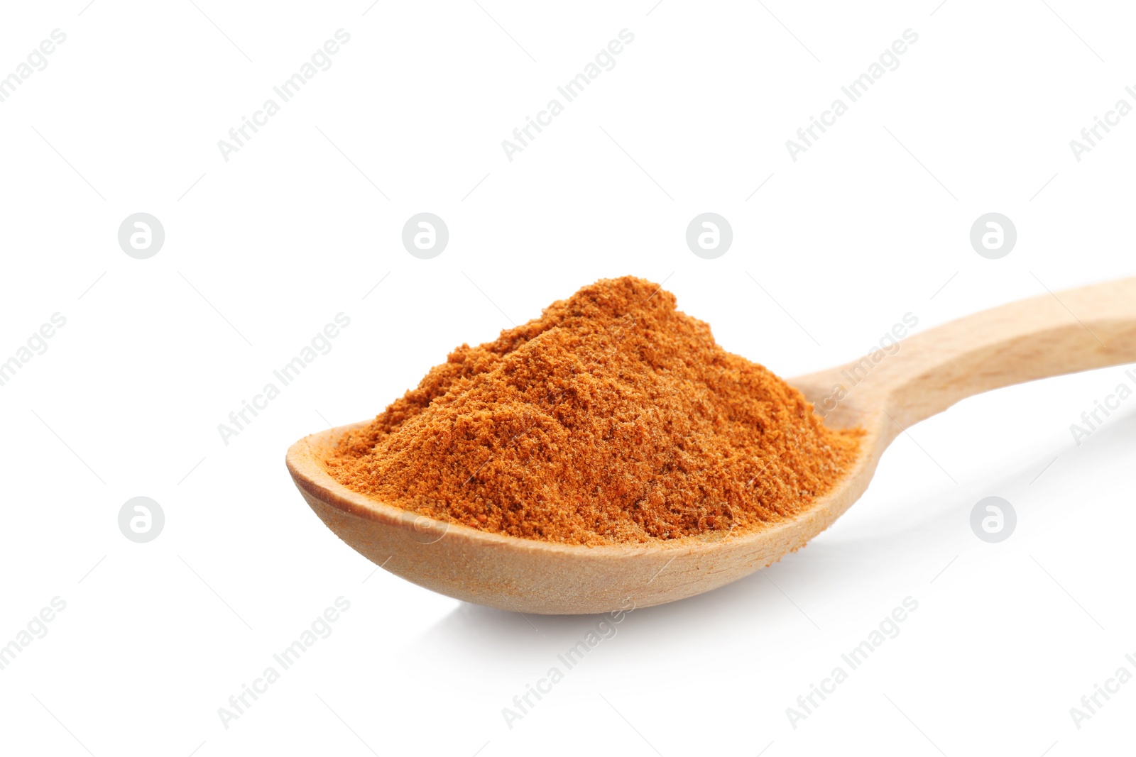 Photo of Wooden spoon with red pepper powder on white background