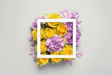 Flat lay composition with beautiful blooming flowers on grey background