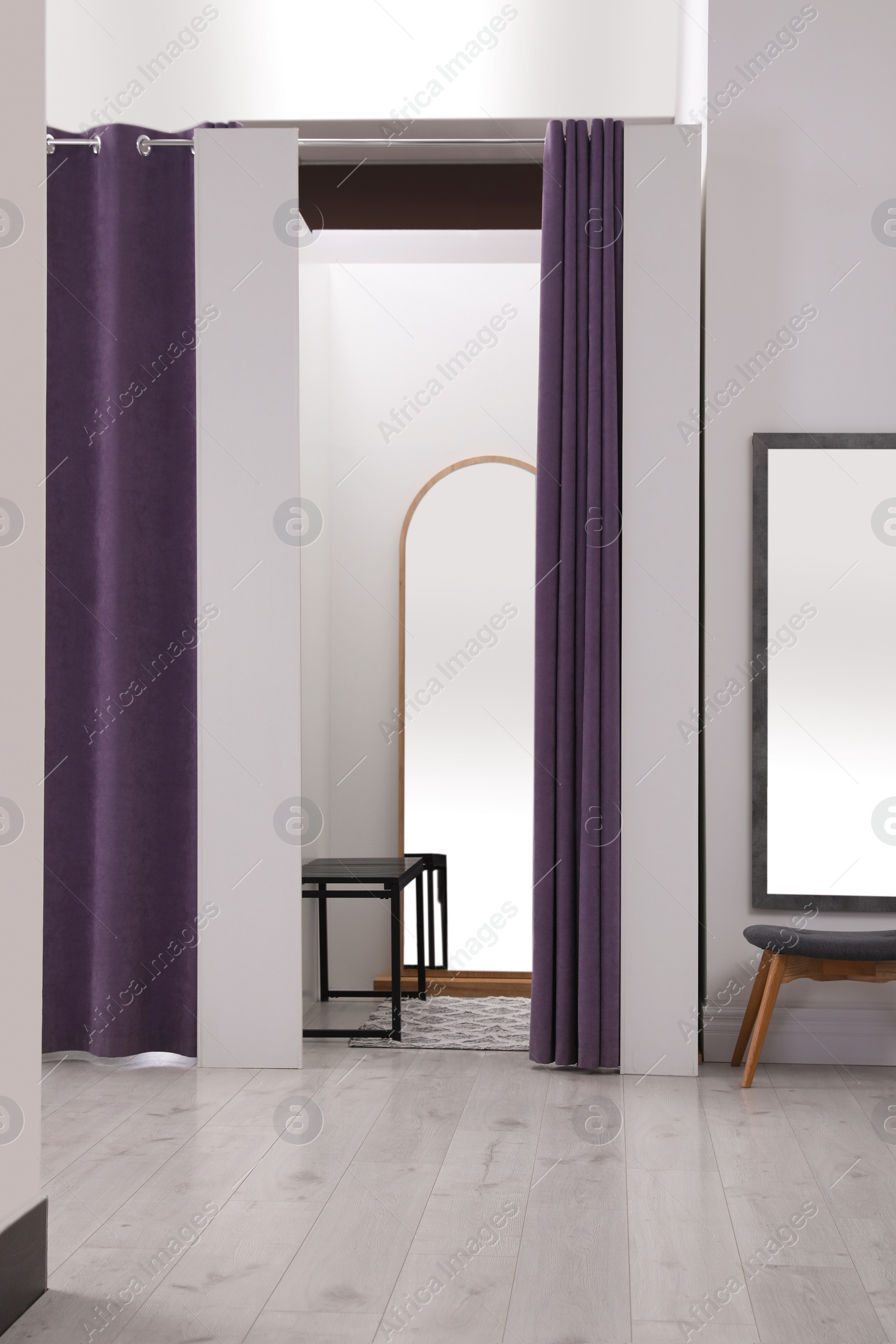 Photo of Empty dressing room in fashion store. Stylish interior