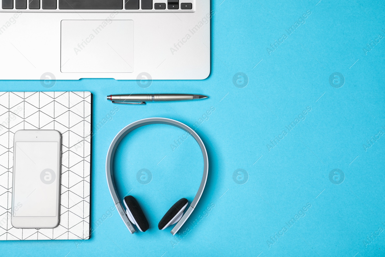 Photo of Flat lay composition with headphones, laptop and space for text on color background