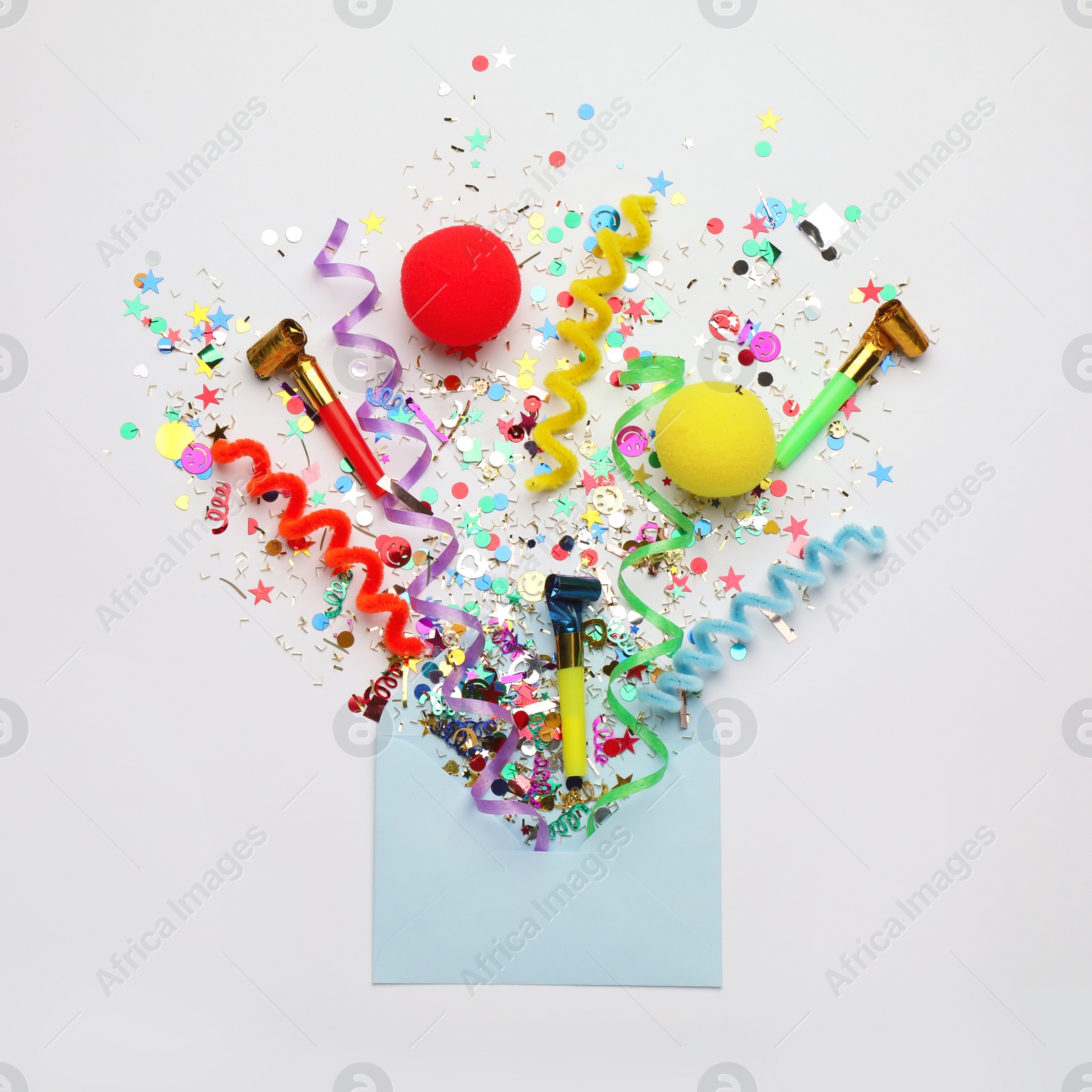 Photo of Beautiful flat lay composition with envelope and festive items on white background. Surprise party concept
