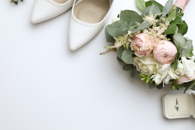 Photo of Composition with wedding high heel shoes on white background, top view