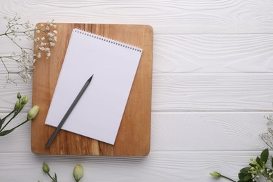 Photo of Guest list. Notebook, pencil and beautiful flowers on white wooden background, flat lay. Space for text