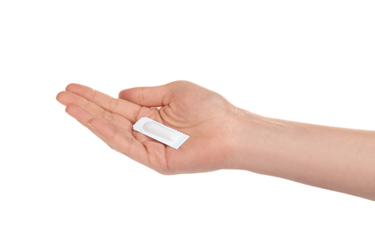 Photo of Woman holding suppository on white background. Hemorrhoid problems