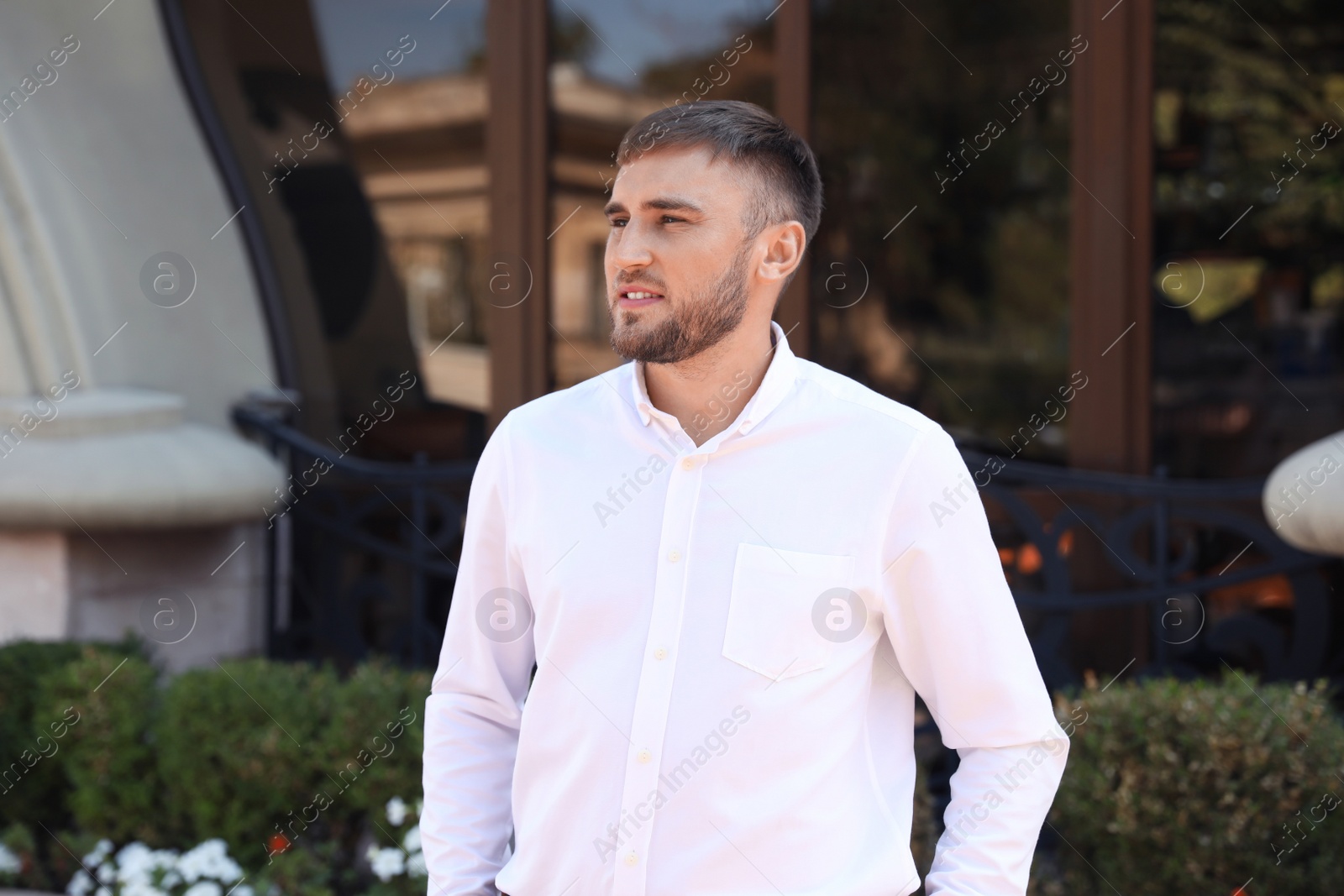 Photo of Portrait of handsome young man on city street