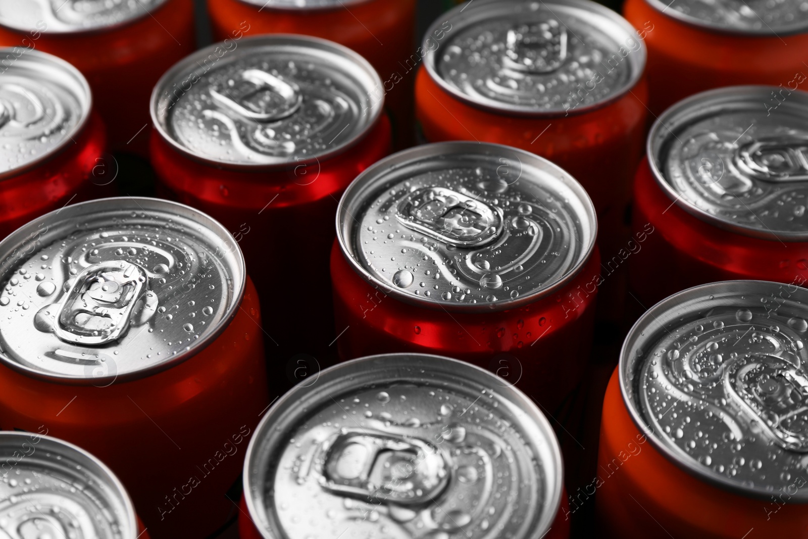 Photo of Energy drink in wet cans, closeup. Functional beverage