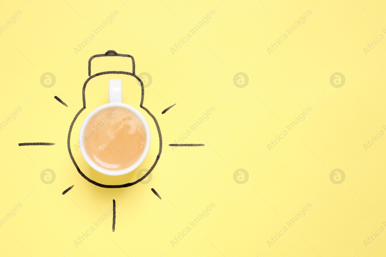 Photo of Cup of coffee and drawn lightbulb on yellow background, top view. Space for text