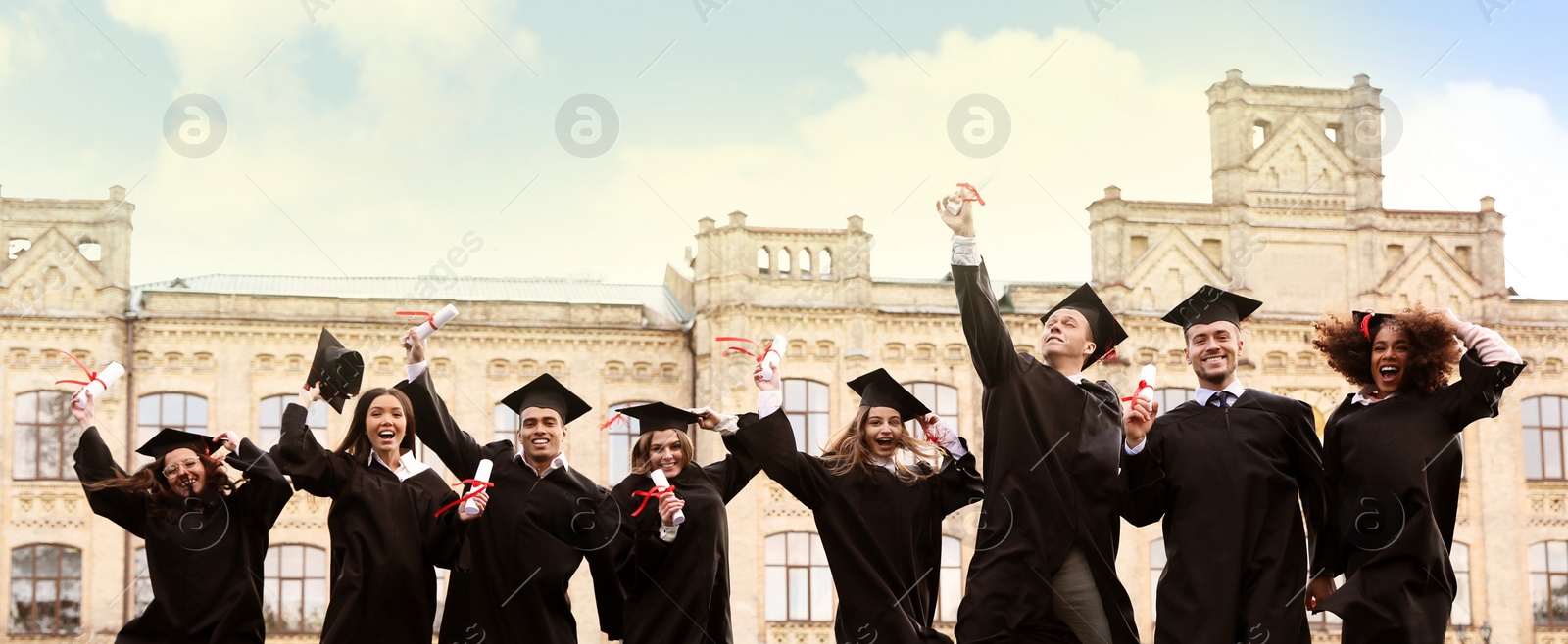 Image of Happy students with diplomas near campus. Banner design