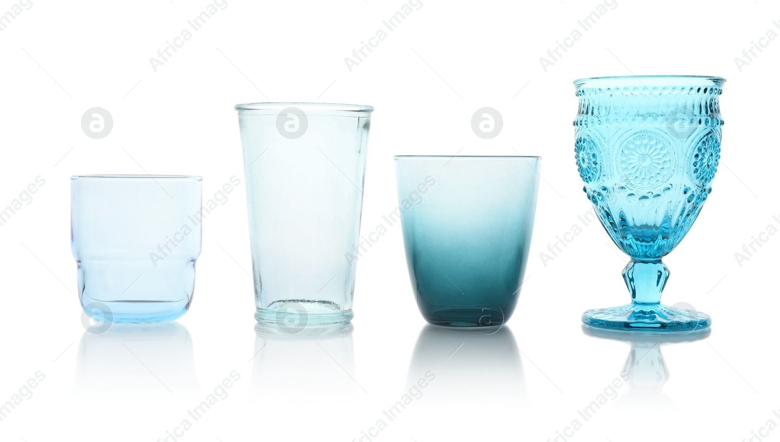 Photo of Set of colorful empty glasses on white background