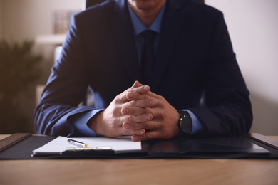 Male lawyer at table in office, closeup