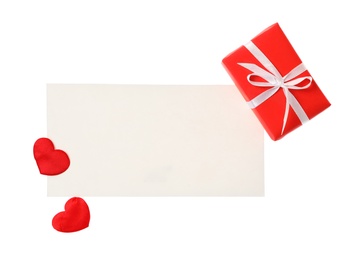 Photo of Blank card and gift box on white background, top view. Valentine's Day celebration