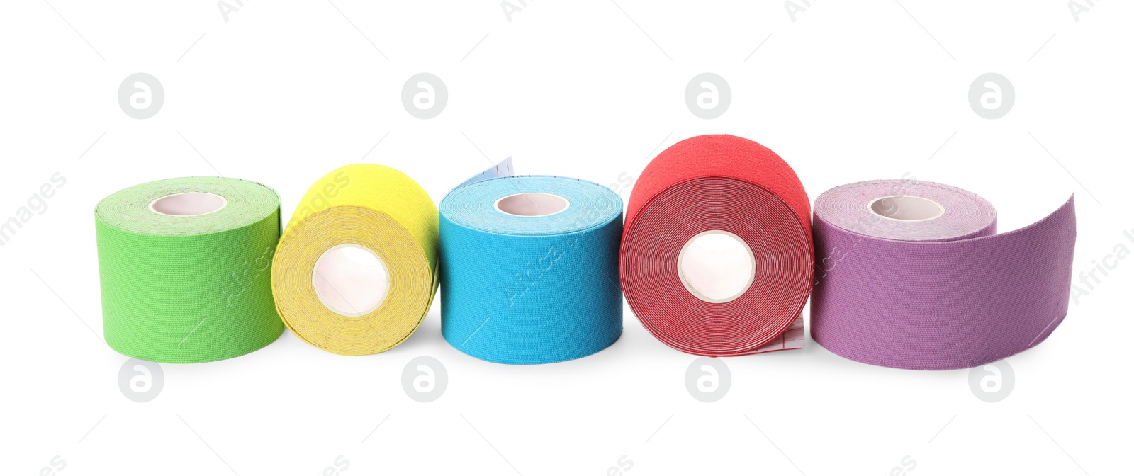 Photo of Many bright kinesio tape in rolls on white background