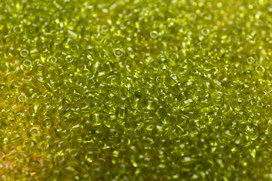 Photo of Bright green glass beads as background, closeup