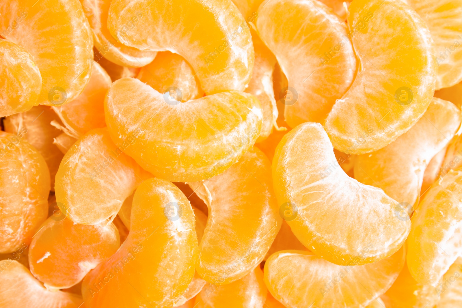 Photo of Pieces of ripe tangerines as background, top view