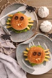 Flat lay composition with tasty monster sandwiches for Halloween party on wooden table